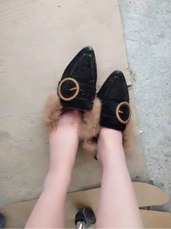 Pair of delicate feet posed together, contrasting skin tones, one bare and one in sheer nylon stockings.