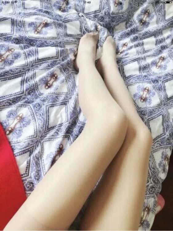 Foot half-slipped from a sheer stocking, toes curled and instep exposed with nylon sheen and soft shadow.