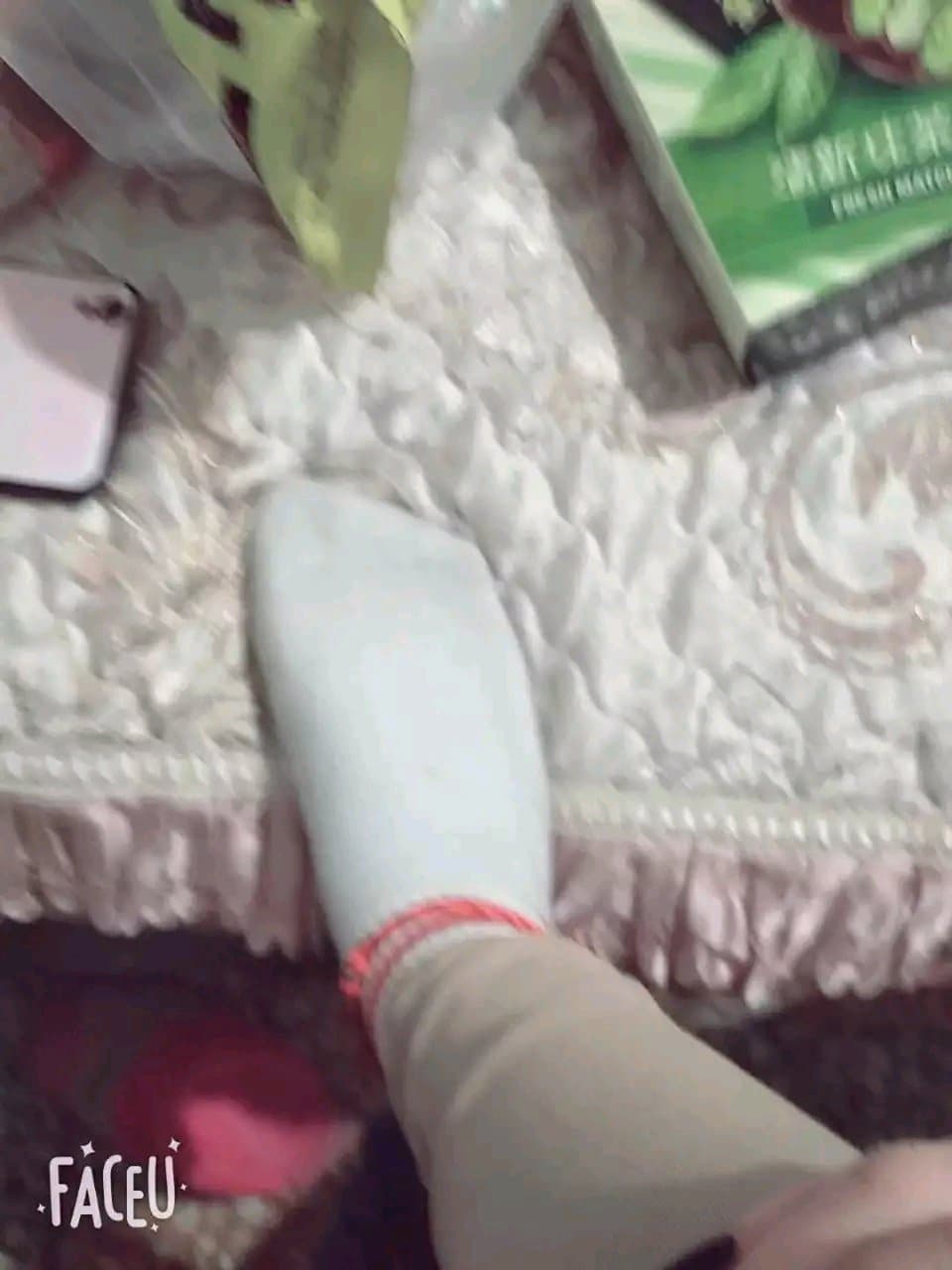 Overhead shot of athletic cotton socks on flexed feet, fabric creases and heel contours visible in soft gym lighting.