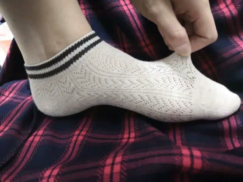 new cotton socks on crossed legs