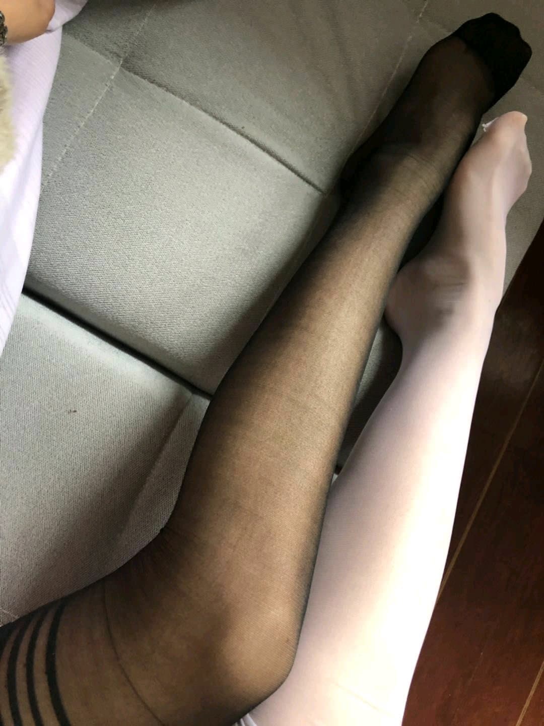 Candid shot of feet in thin stockings resting on a vintage rug, slight motion blur adding a lived-in feel to the scene.