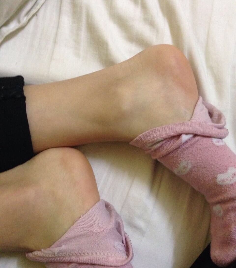 Close-up of soft pink cotton socks snugly covering toes with visible knit texture