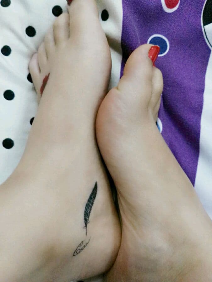 Artful close-up of stocking-clad toes curling against soft fabric under dramatic lighting