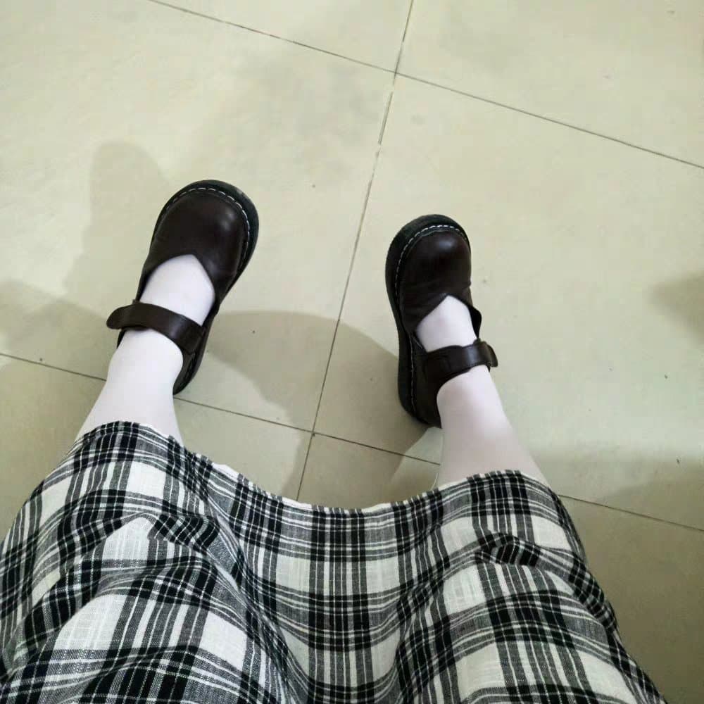 Newcomer feet posed shyly, one foot half in a fresh cotton sock beside sheer nylon.