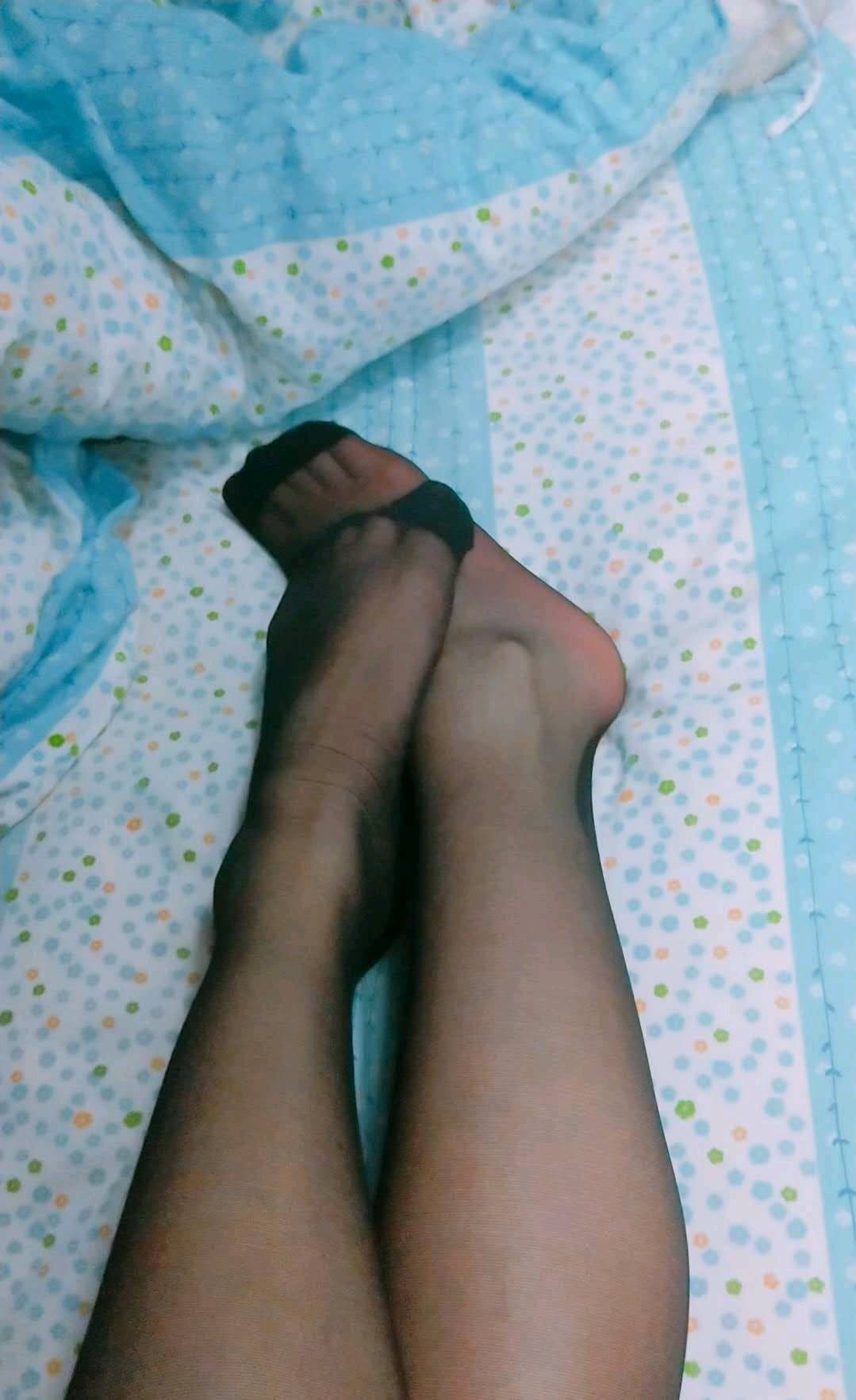 Casual snapshot of adult feet in slightly worn cotton socks, socks slouched around ankles at rest.