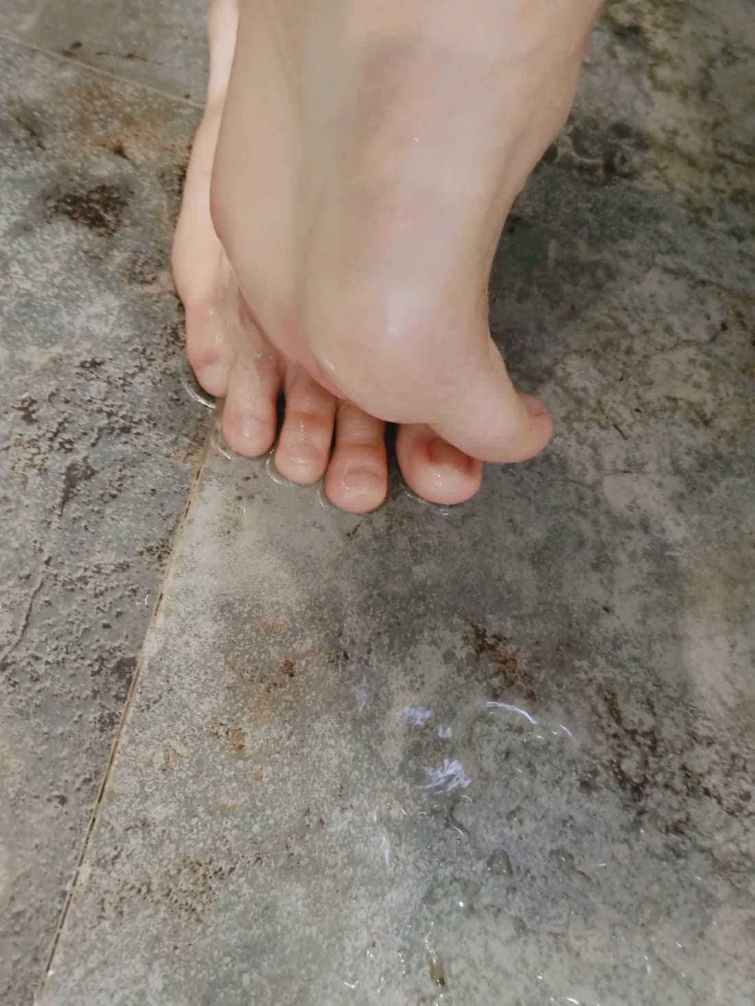 Close crop of feet highlighting a longer second toe, neutral background, soft shadows emphasizing shape