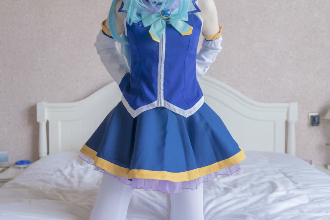 Aqua-lit close-up of pantyhose-clad toes, glossy nylon reflecting cool blue light over a relaxed foot.