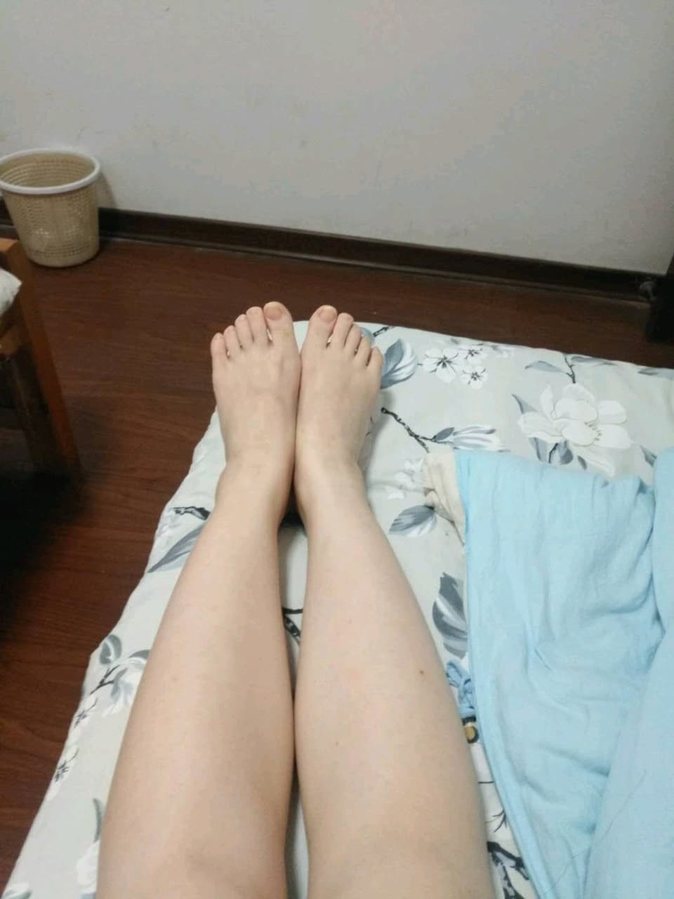 Friend guiding a partner’s foot, hands adjusting sheer nylon while toes curl in playful instruction