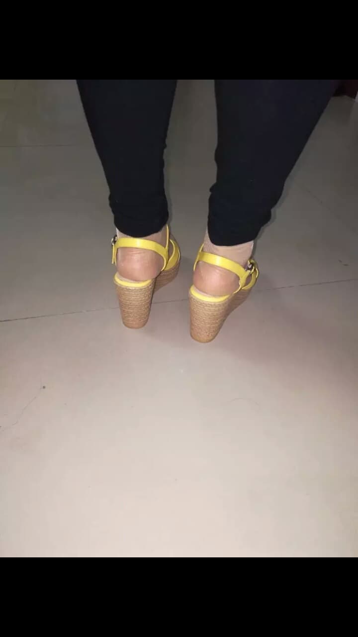 Silk sandals with short straps revealing toes and nylon stockings, toes peeking through in a flirtatious scene