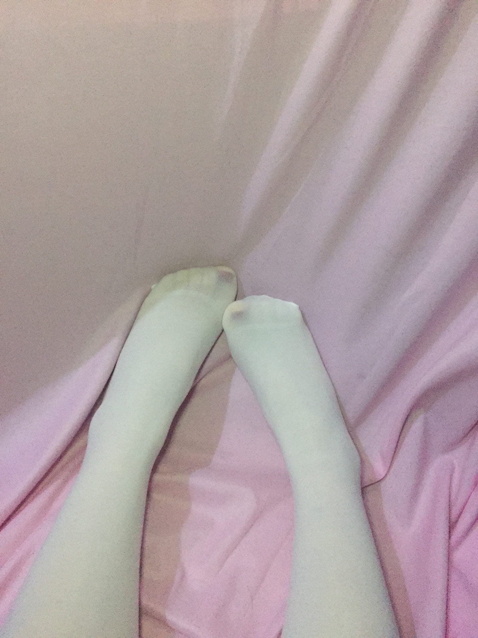 Glossy black silk wrapped around slender Asian ankles, sheer nylon accentuating toes and arches in soft lighting