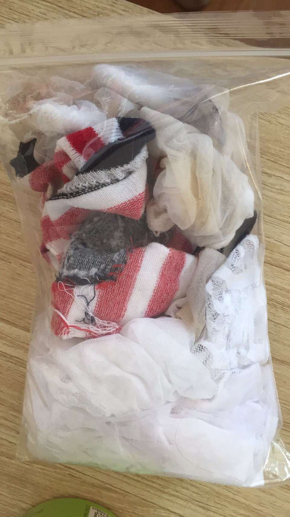 Relaxed bare feet beside bunched cotton socks on chair