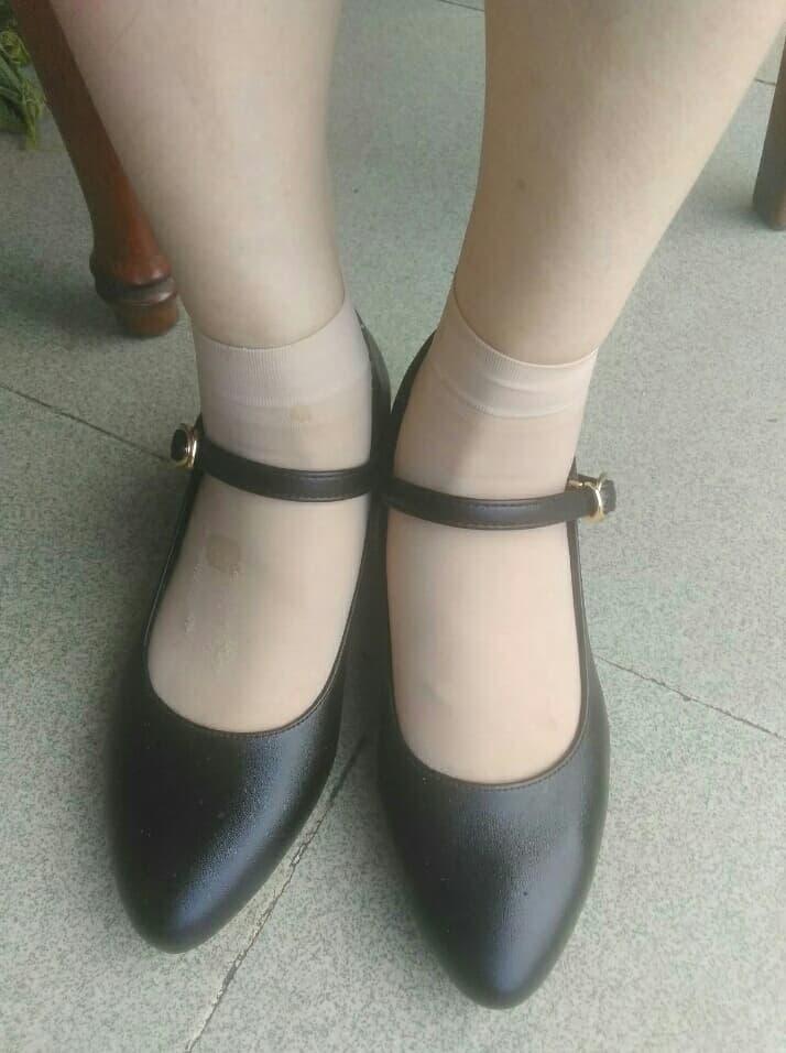 Short silk stockings hugging ankles with glossy black heels
