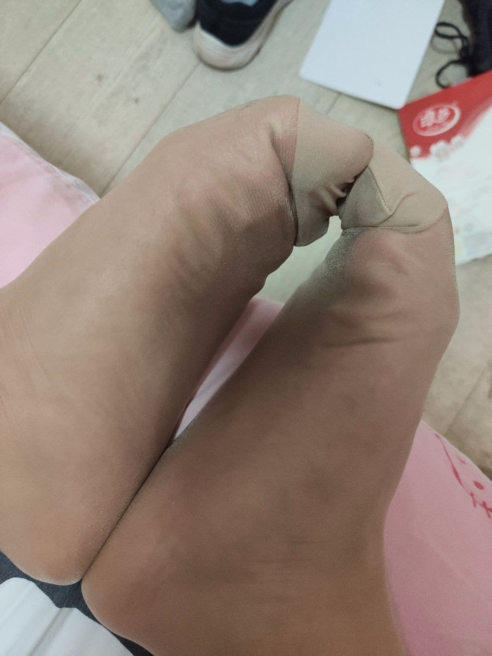 Quick candid of a foot slipping from a shoe, stocking peeking at the heel, casual pose turned unexpectedly intimate and suggestive.