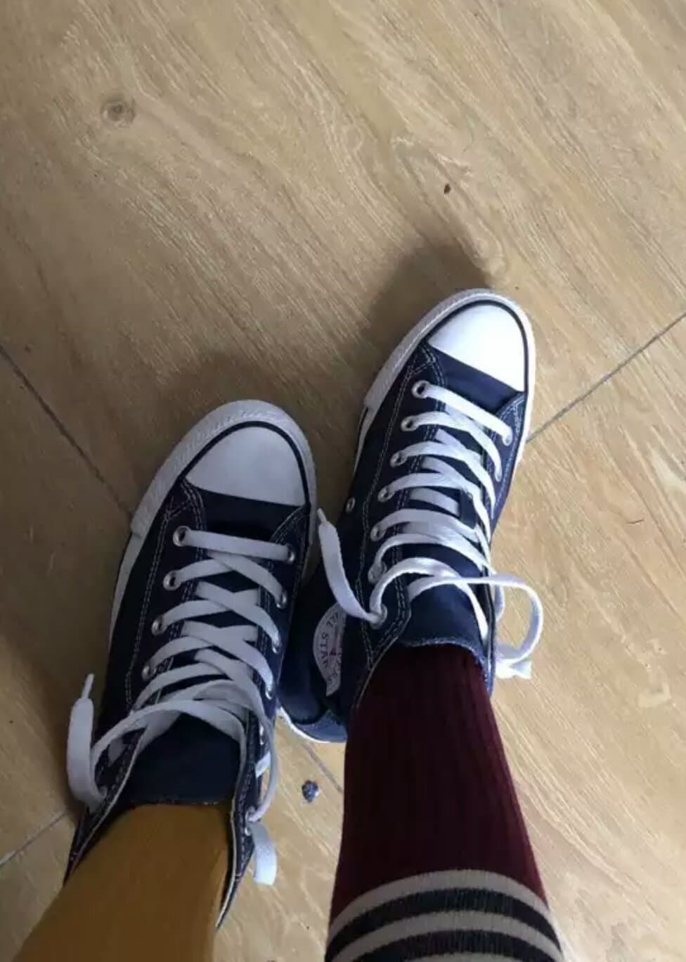 Over-the-knee socks hugging a slender thigh, fabric texture visible, slight gap revealing skin and a hint of bare knee.