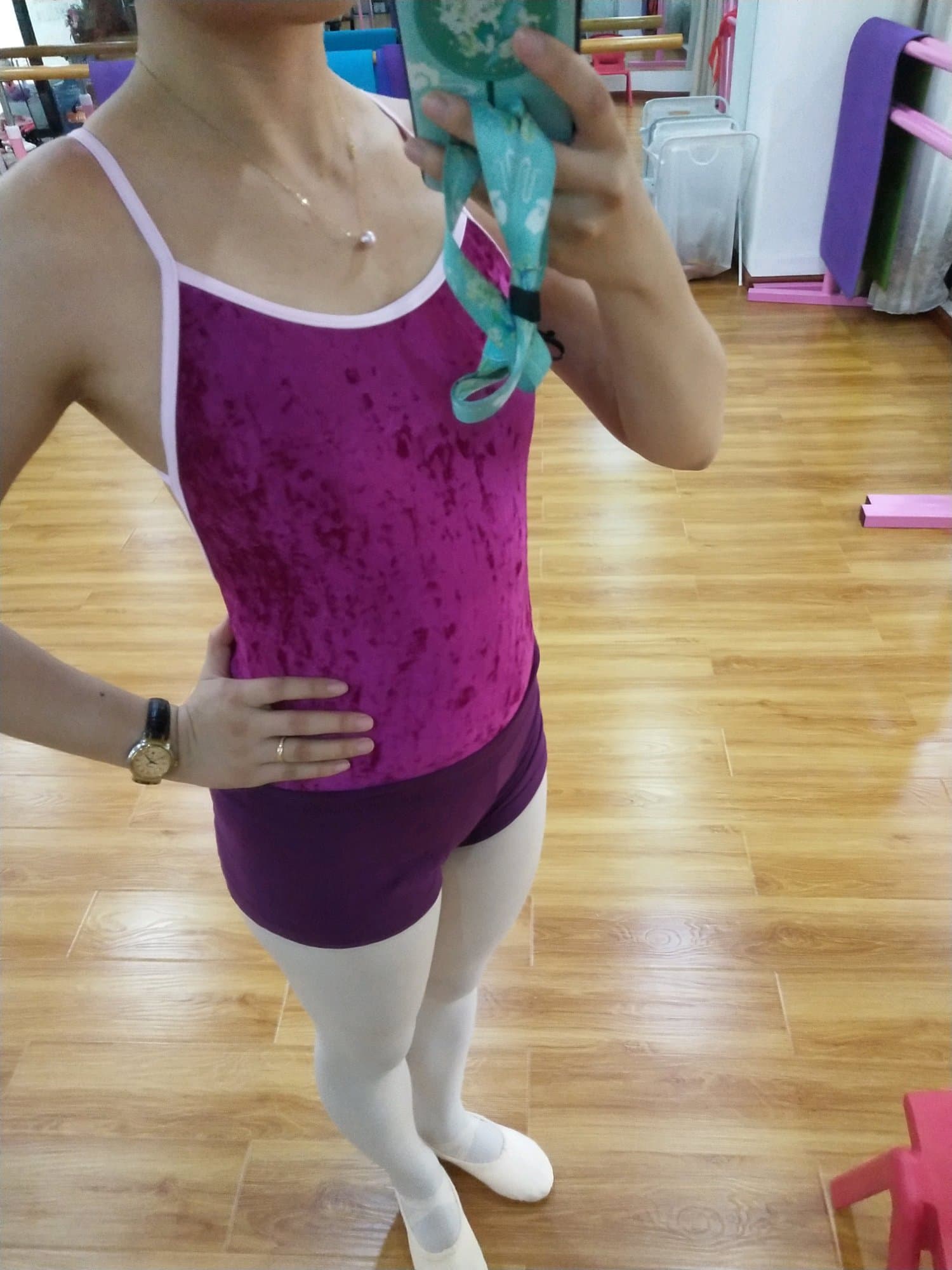 Ballet practice close-up showing blue sock covers hugging the foot against white silk tights and slight creases