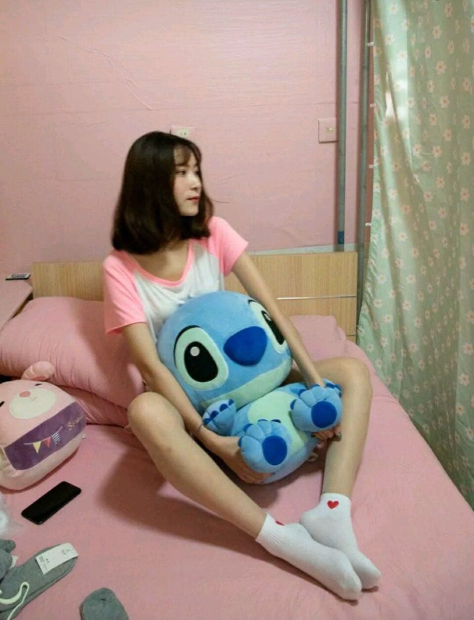 Freshly photographed feet in mid-pose, one stocking partially rolled down to reveal skin