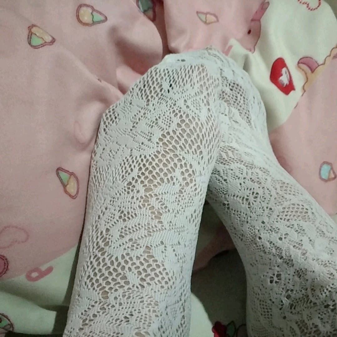 Close-up of bare soles resting on satin, toes slightly curled and inviting