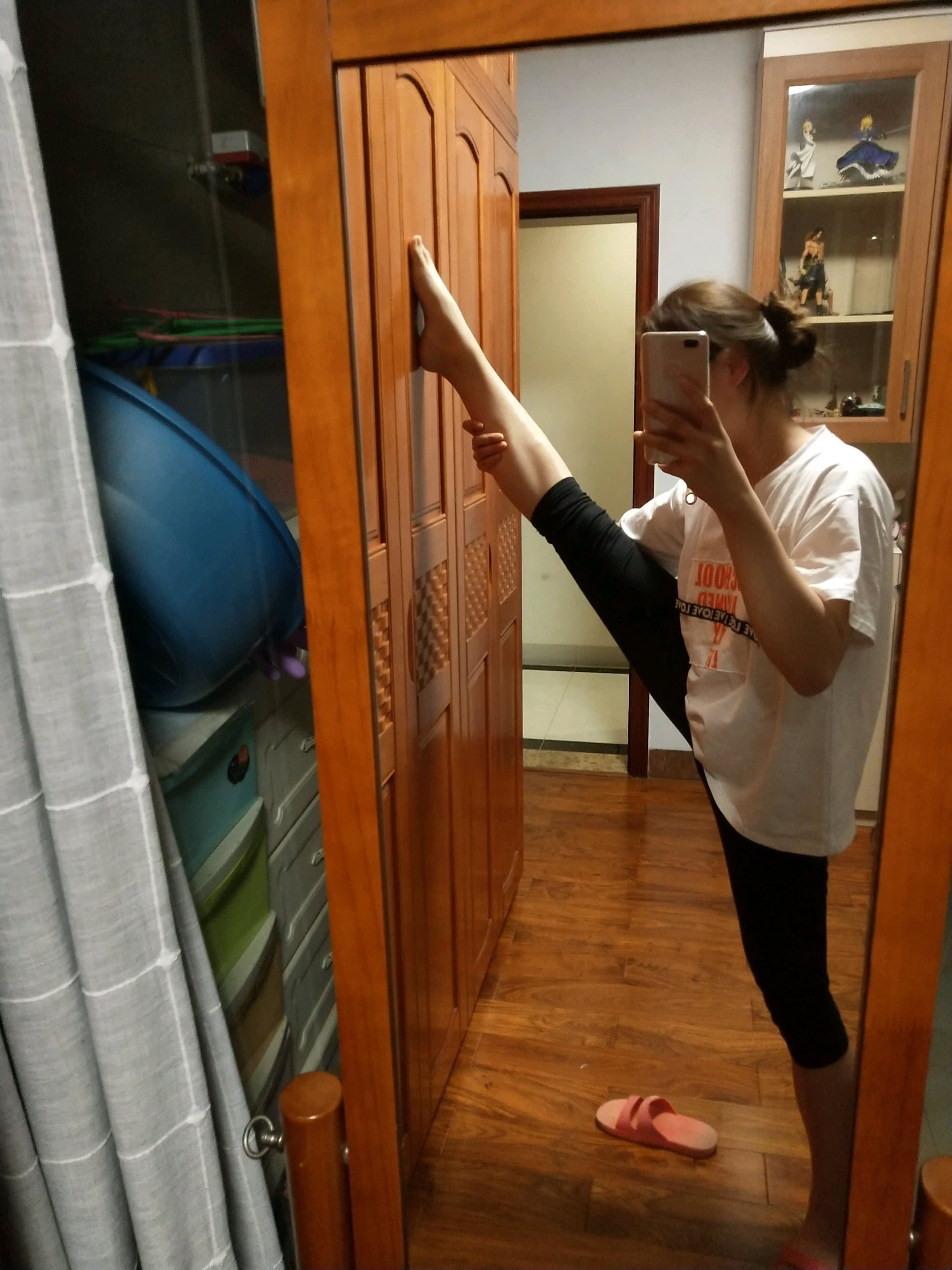 Single foot in shimmering golden stockings, toes polished and arch elegantly highlighted