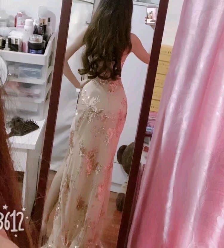 Confident pose of bare feet wearing glossy stockings, toes pointed to emphasize a high arch and smooth skin