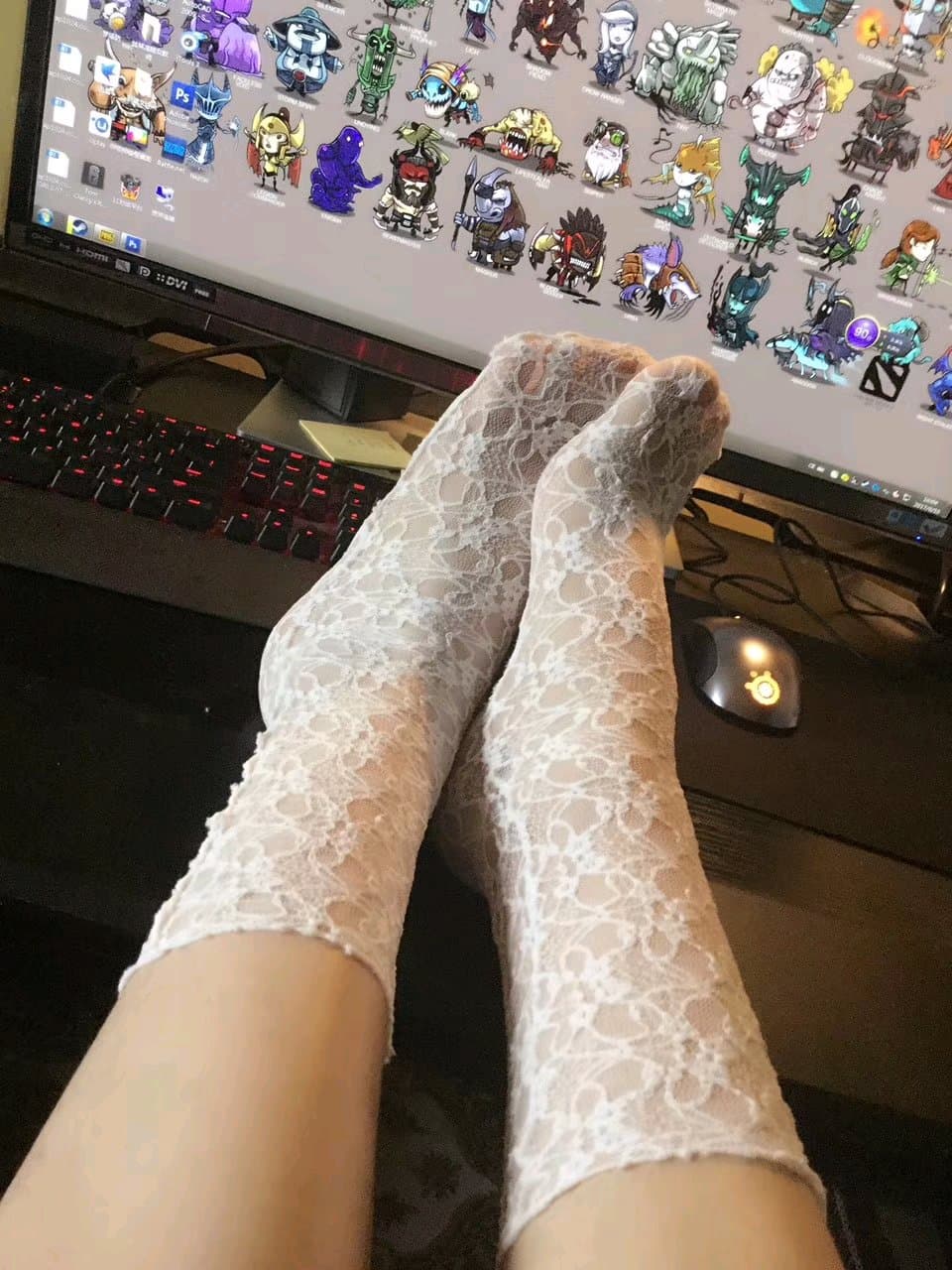 Bare foot slipping from a silk stocking, toes curling slightly, captured in soft bedroom light