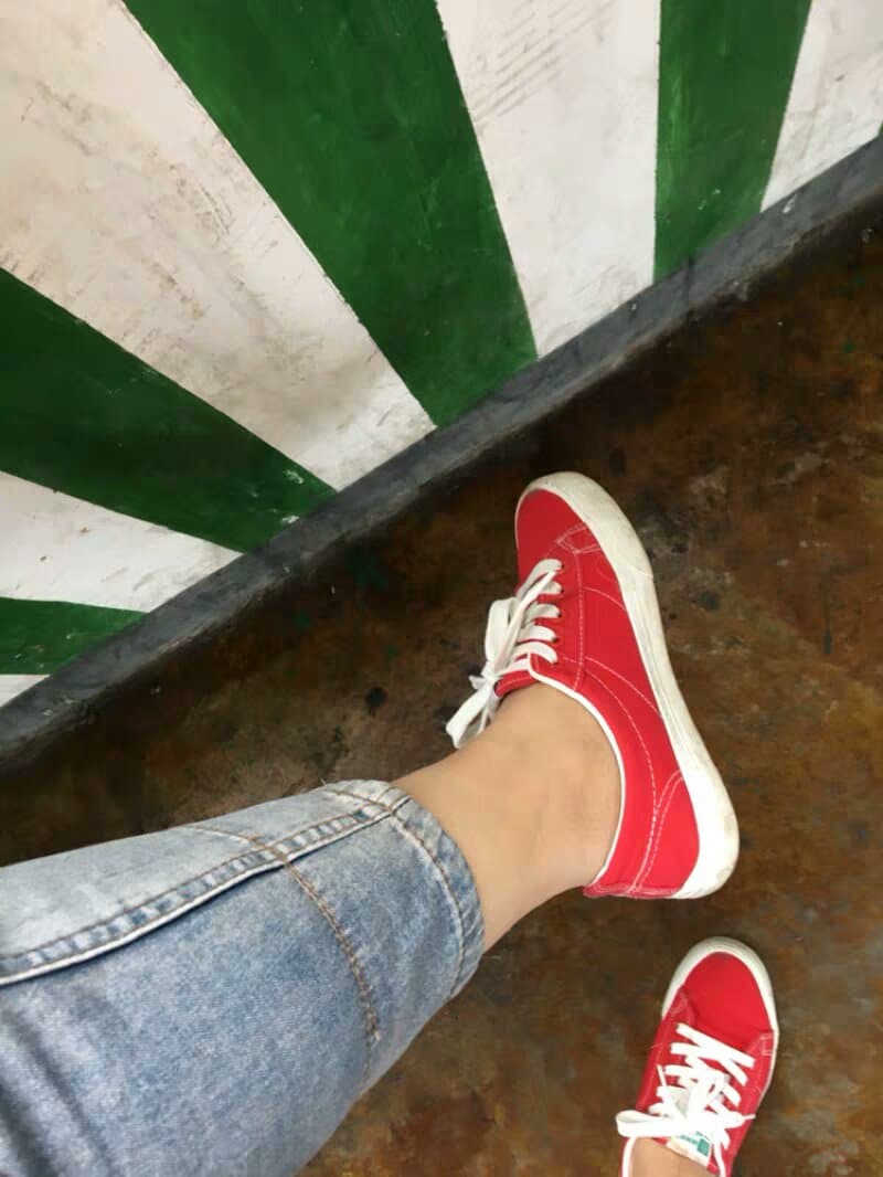 Playful close-up of toes peeking from rolled boat socks, hint of nylon nearby