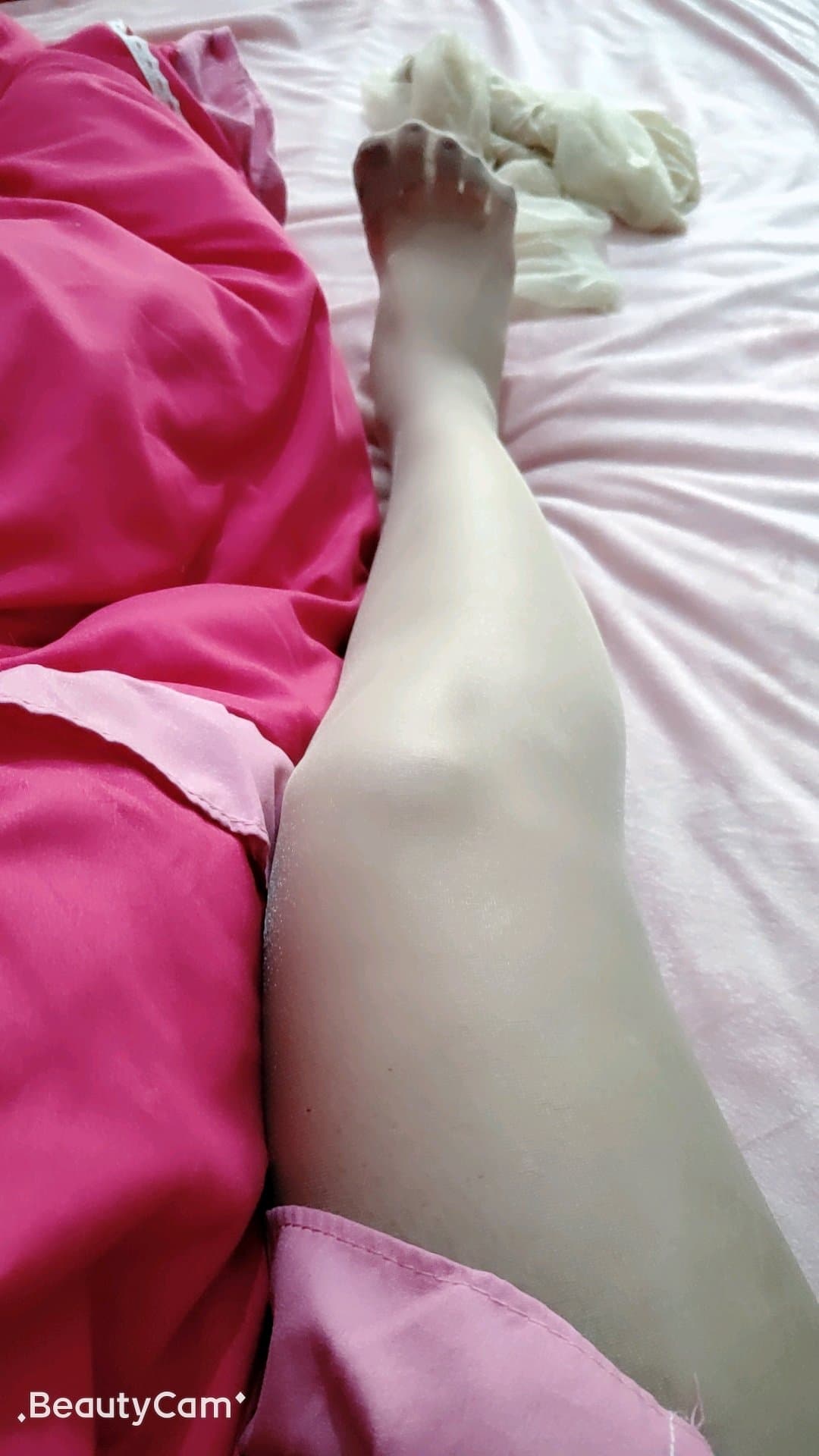 Petite bare feet with high arches and neatly aligned toes on a soft blanket, intimate close-up