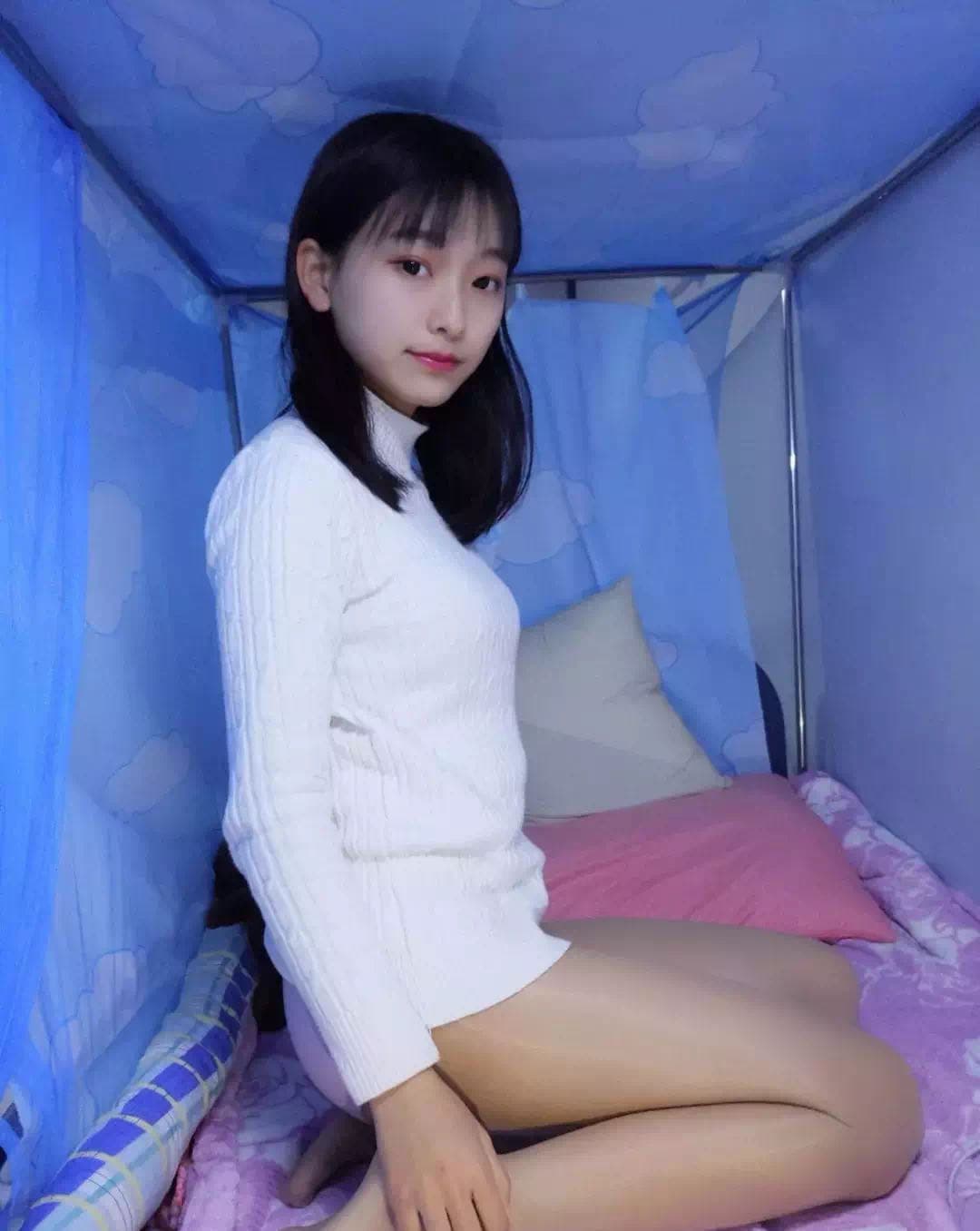 Anonymous figure in sheer stockings with bare toes visible, cropped to emphasize legs and hosiery details