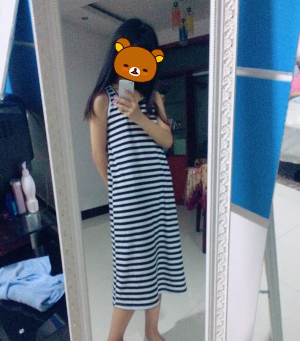 Playful cat nudging a stocking-clad ankle while toes peek out from sheer nylon in warm indoor light