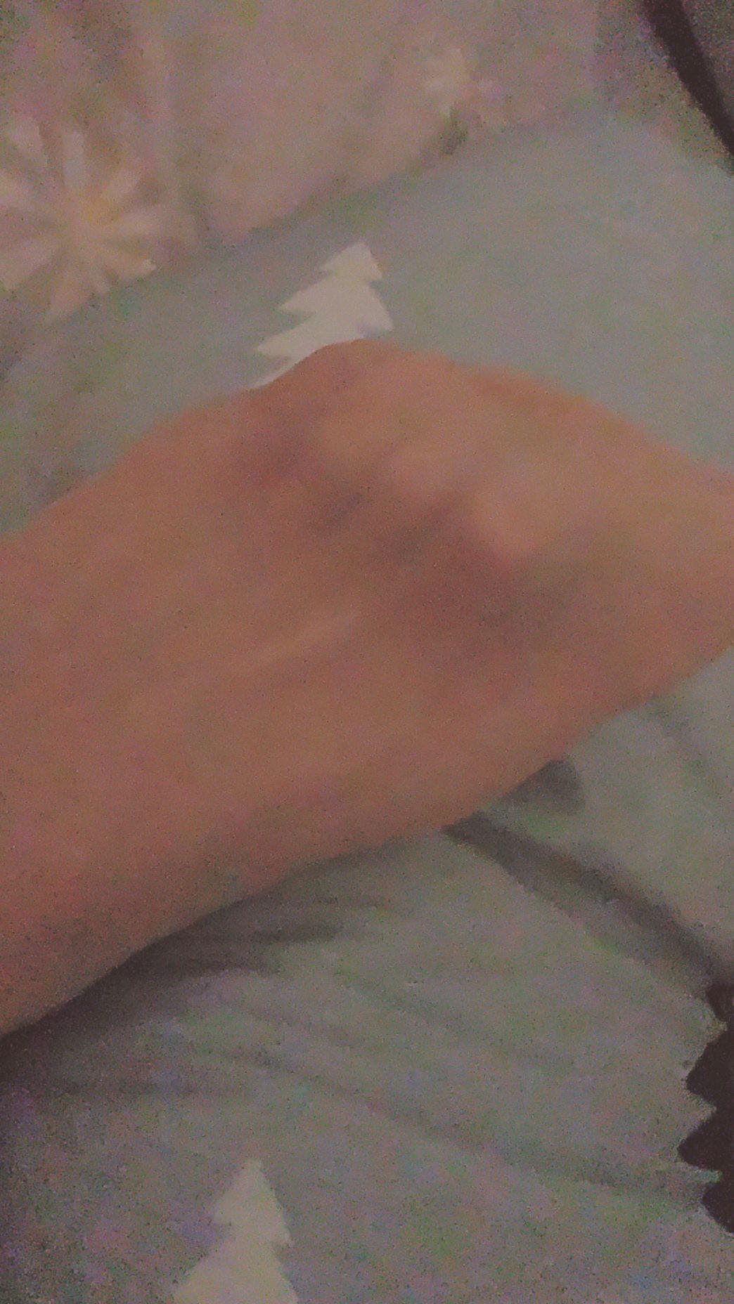 A teasing portrait of a leg in sheer nylon, calf angled, stocking sheen catching light, suggesting a hidden, private moment.