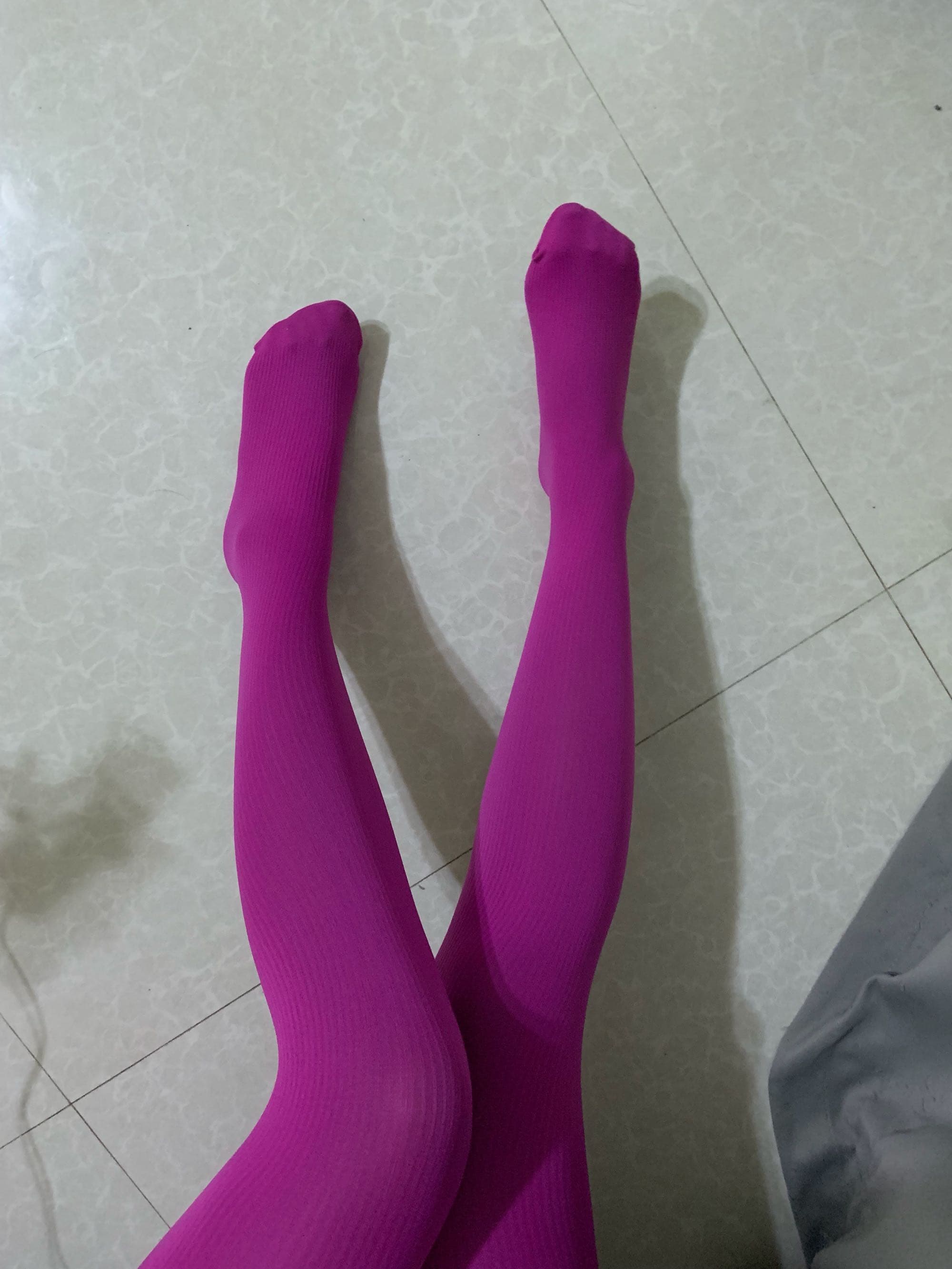 Close-up of thick summer socks on a bare ankle, fabric slightly rumpled from warm skin contact.