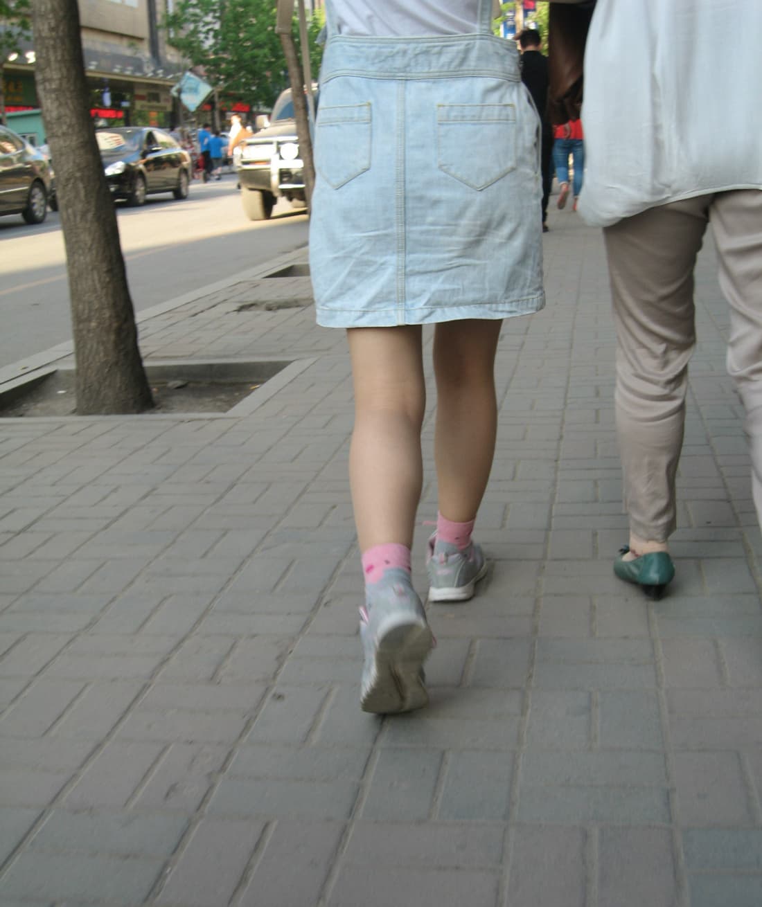 Sunset backlight on flesh-colored pantyhose, glossy surface highlighting leg contours and delicate ankle curves softly