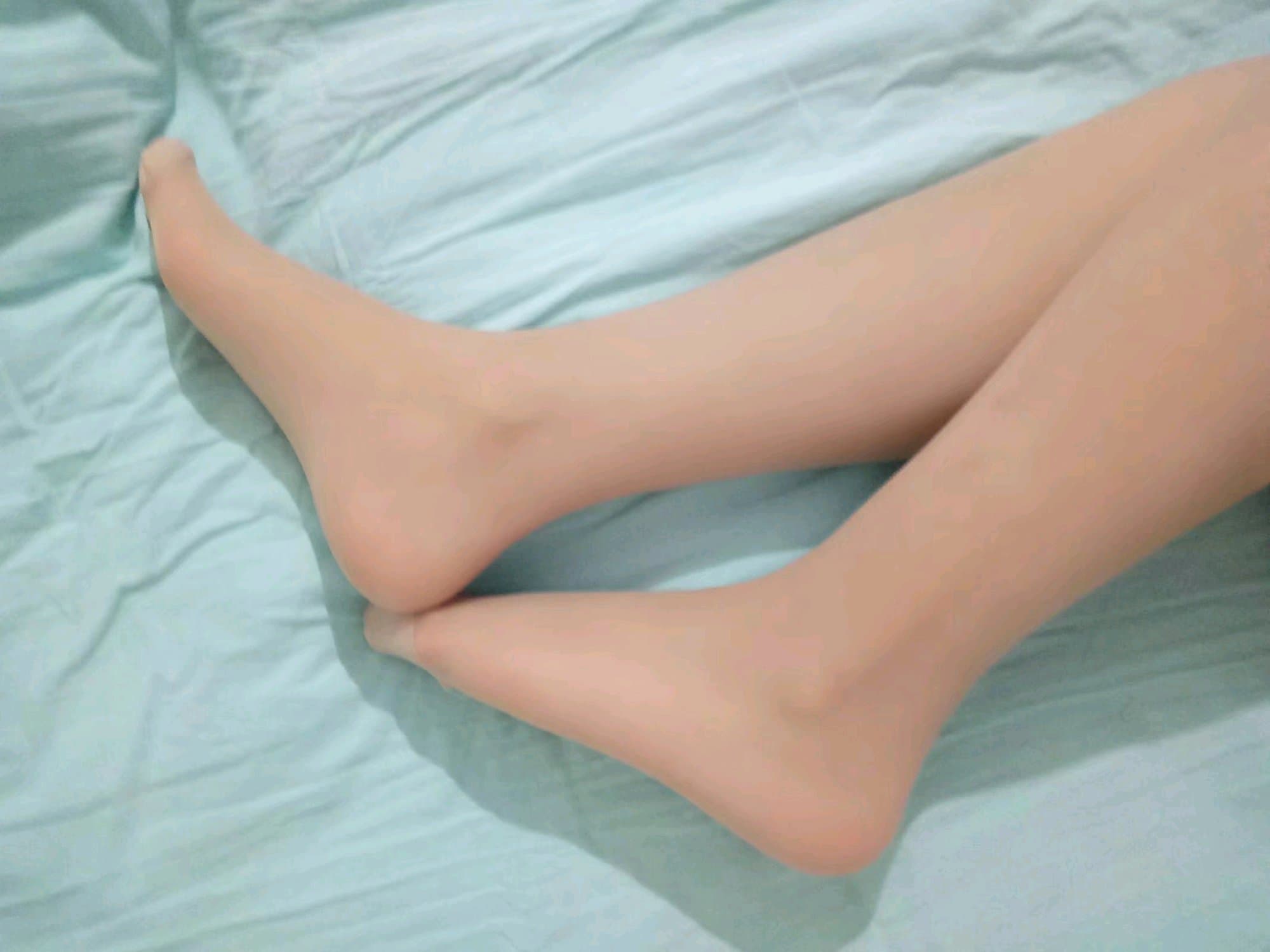 Worn cotton socks crumpled at heels, faint discoloration and soft fibers hinting at a day's journey and sweat