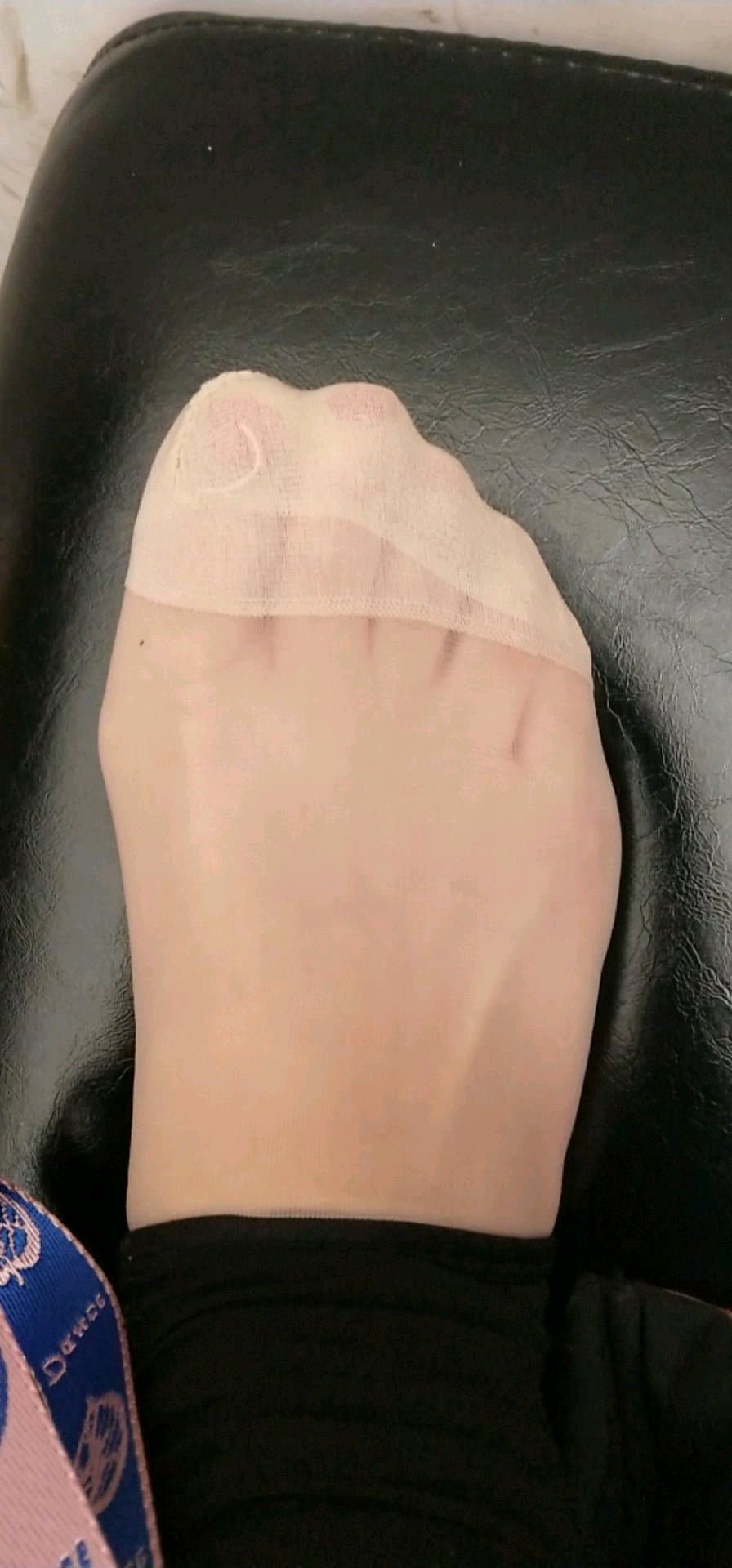 Framed shot of ankle with short silk sock, subtle sheen and creases hinting at recent wear and intimate presence