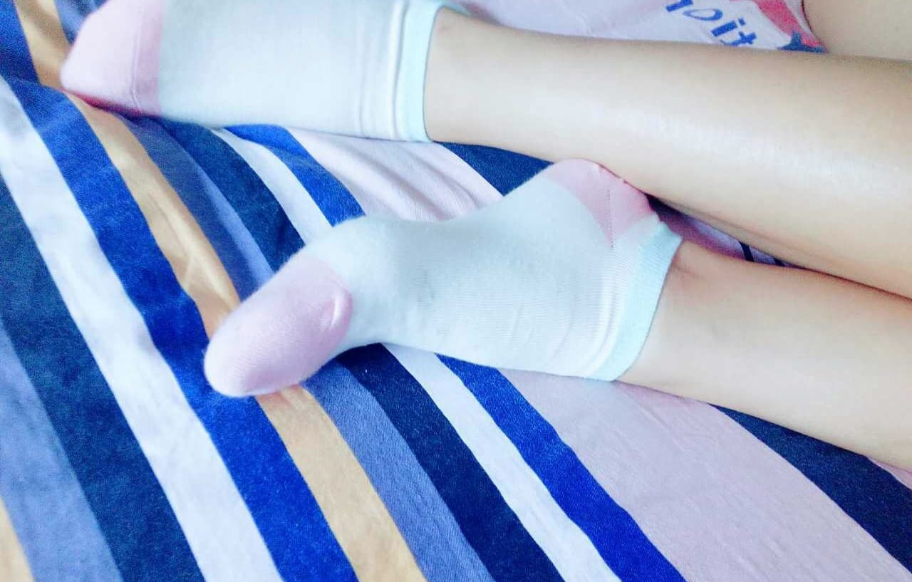 A diverse collection of adult women’s feet shown in sheer nylons, opaque socks, and bare arches with natural, inviting poses.