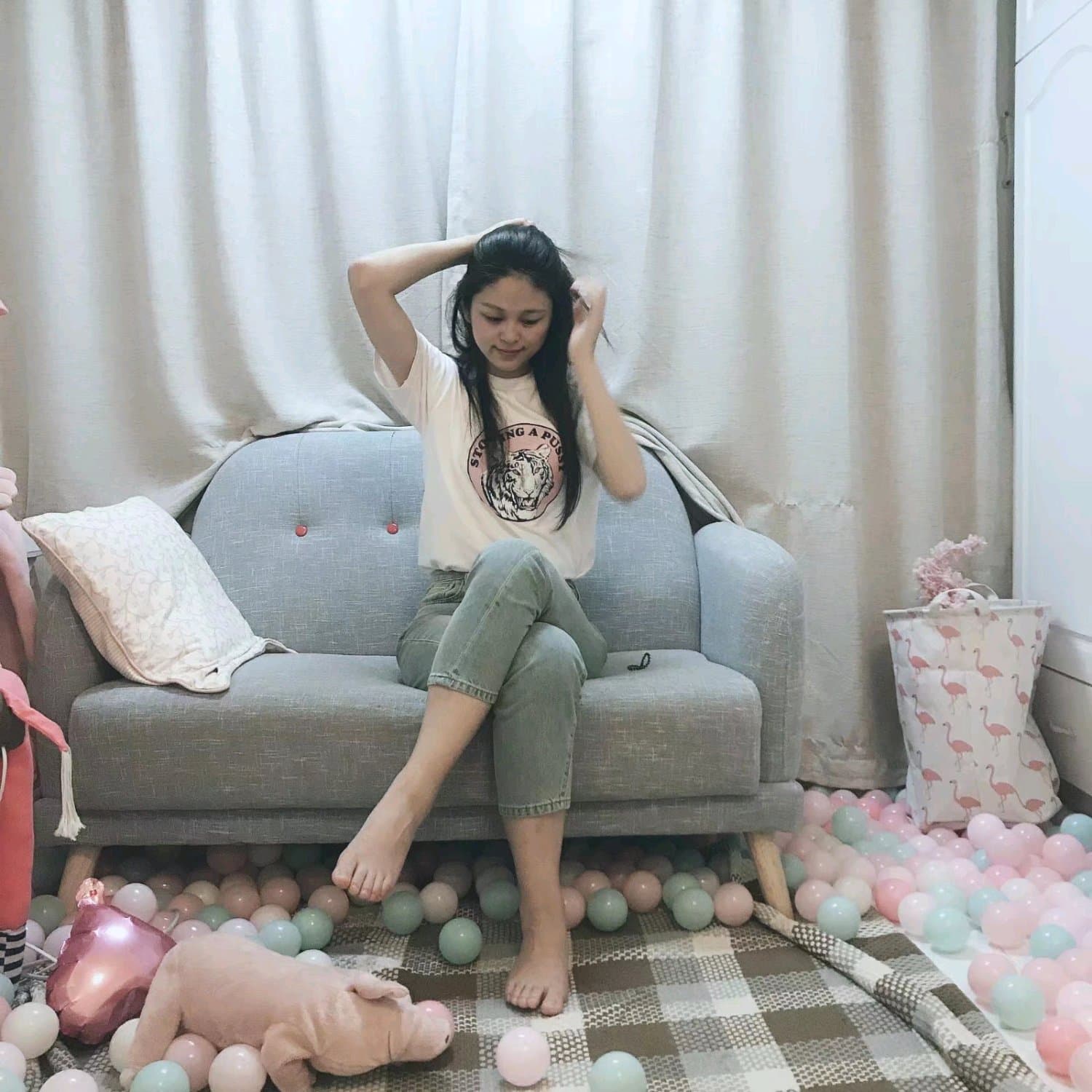 Seductive feet posed on a bed with one sock halfway off, toes flexing as if calling for private attention and touch.