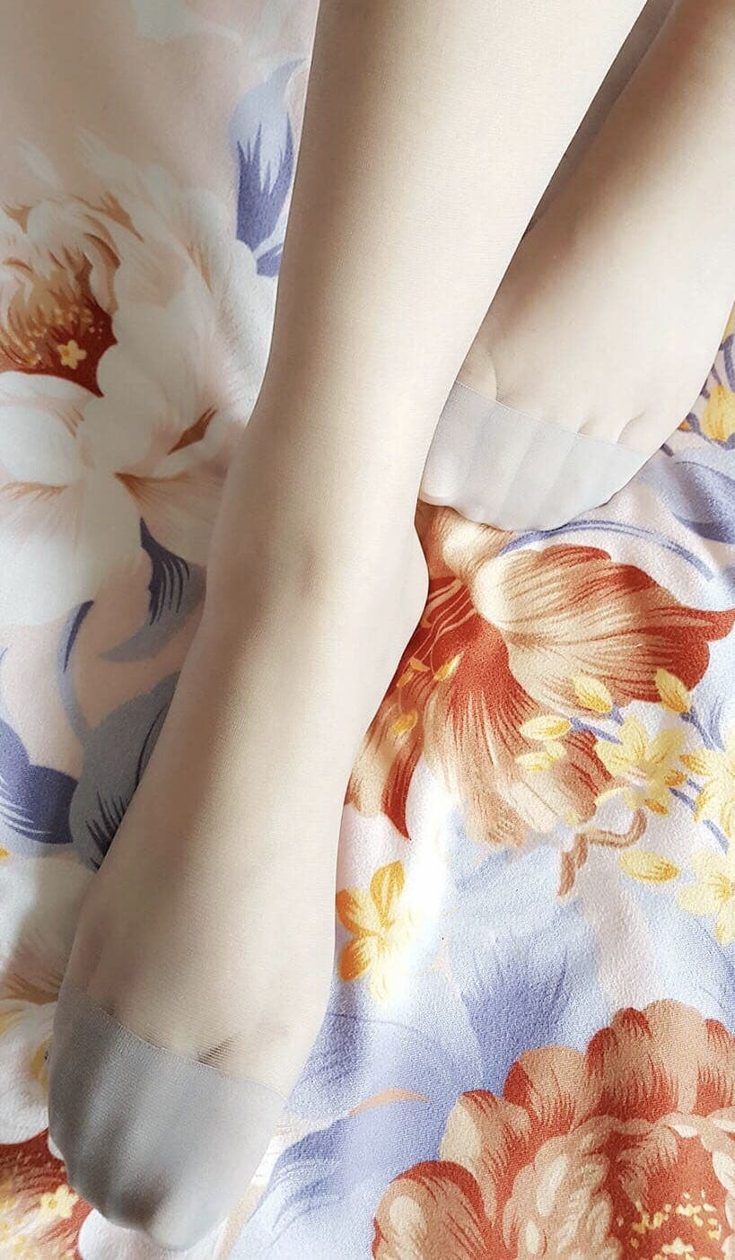Unfiltered shot of a bare foot resting on a rug, showcasing natural skin texture and a relaxed arch