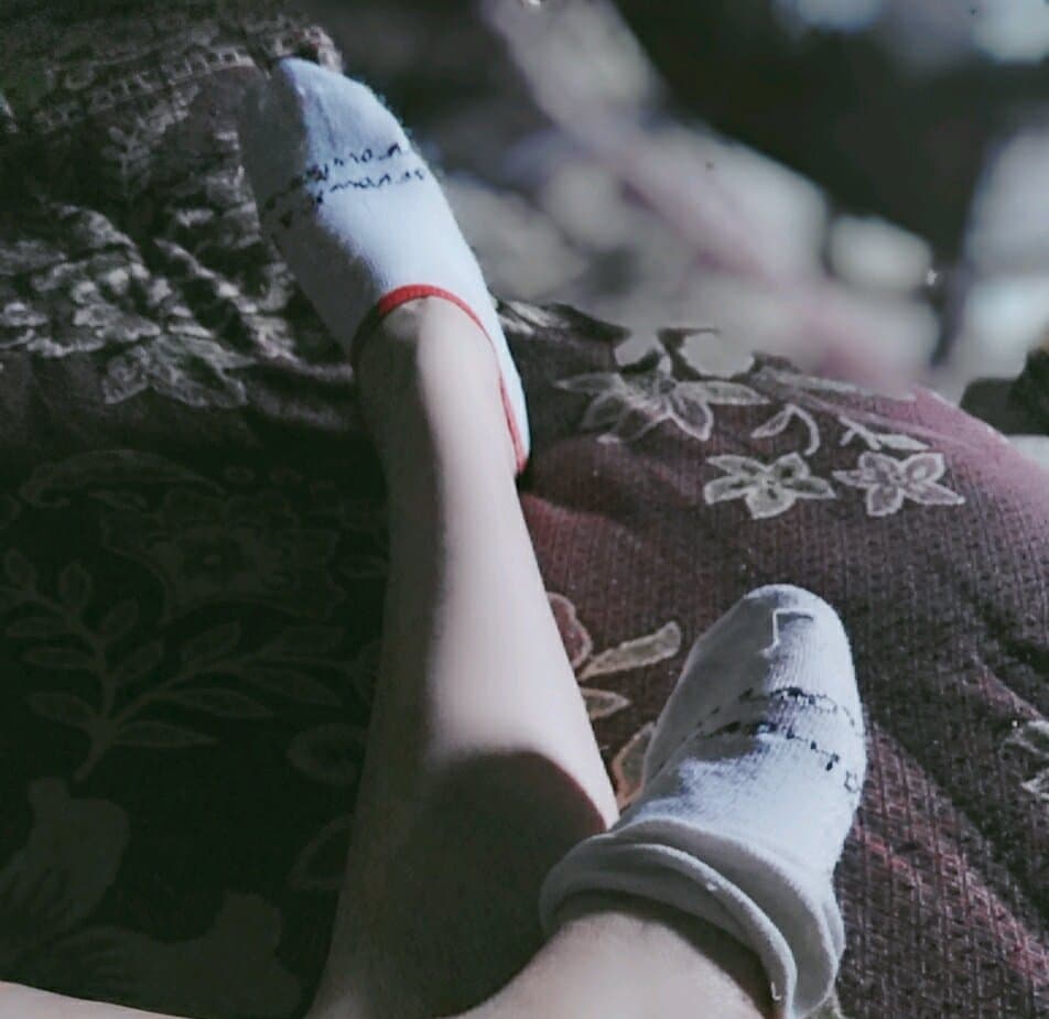 Socked foot with visible wear