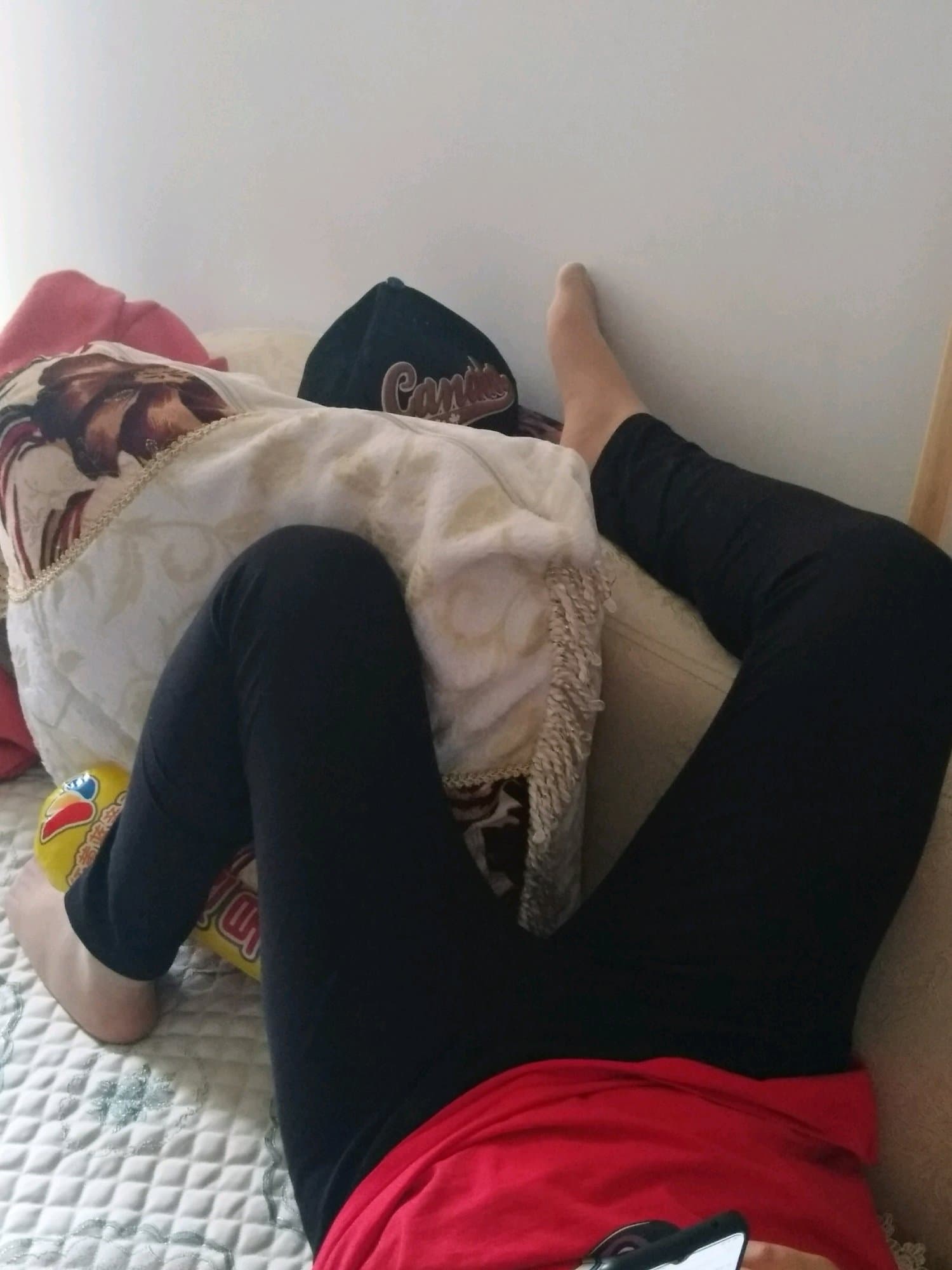 Pair of slightly worn cotton socks discarded on hardwood, one sock half-rolled showing a bitten toe