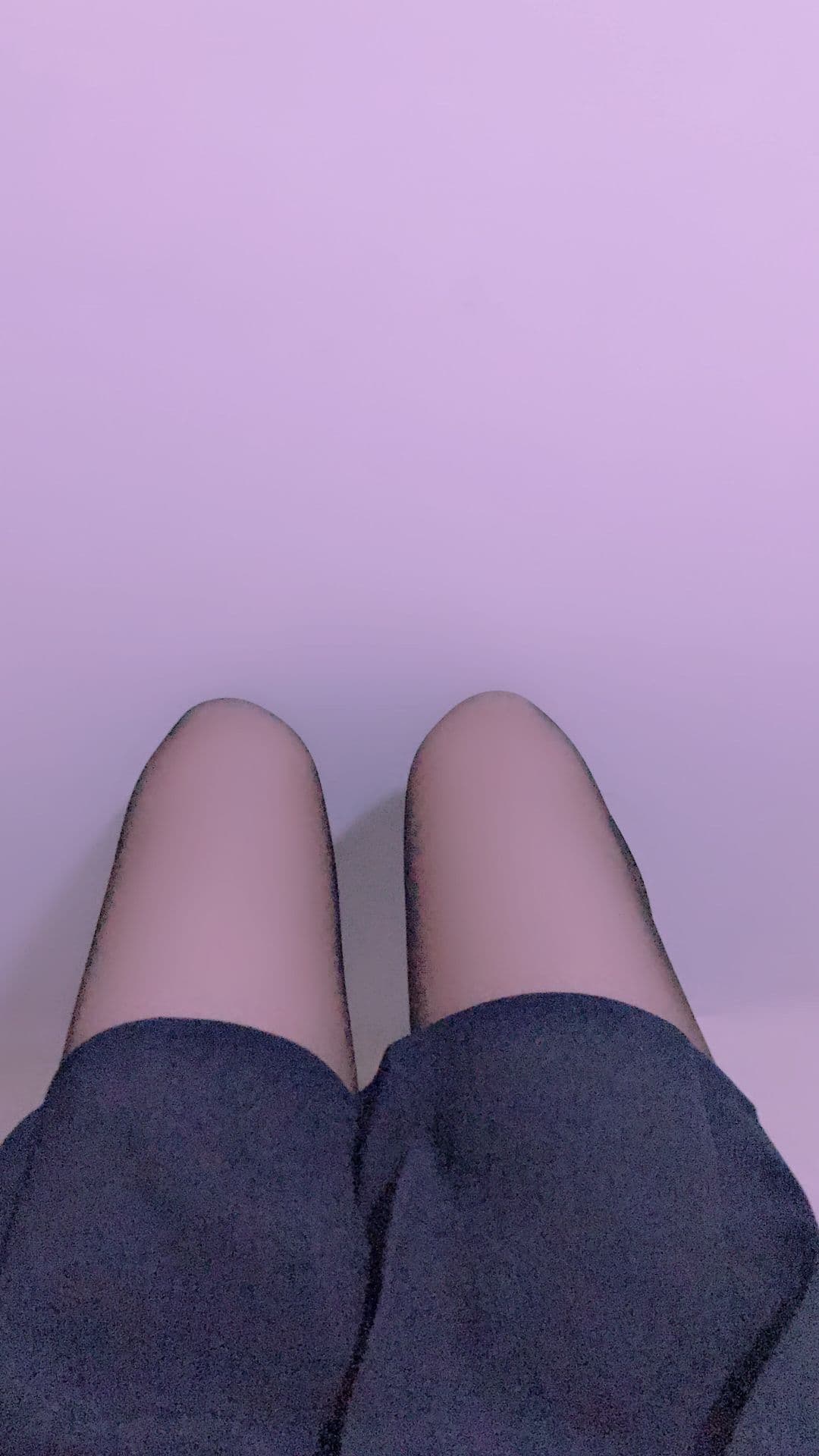 Closeup of nylon-covered toes and slightly worn ankle socks with a soft arch in warm indoor light