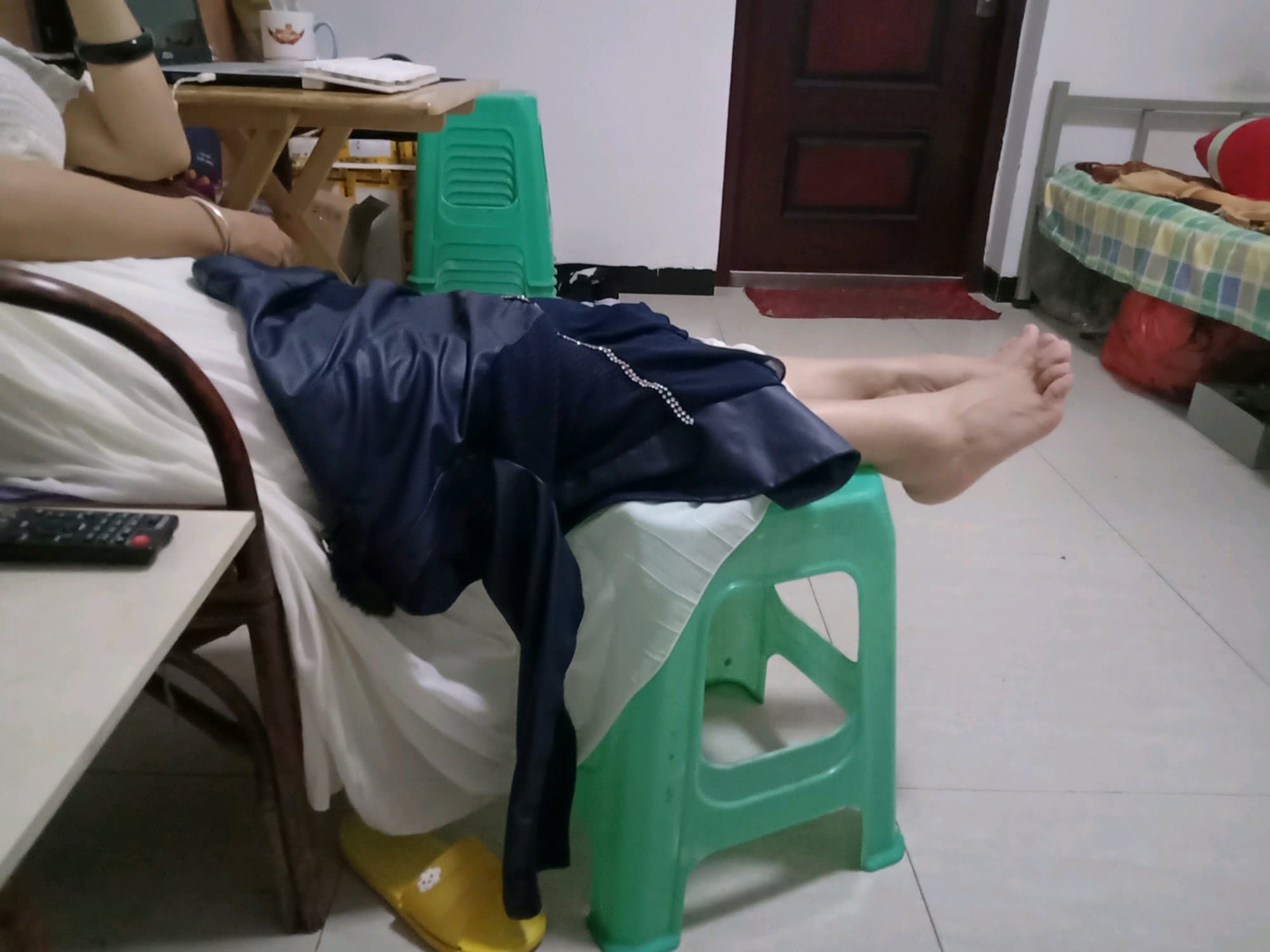 Bare feet resting on a soft rug, nylons rolled down to ankles and toes slightly spread in a relaxed pose.