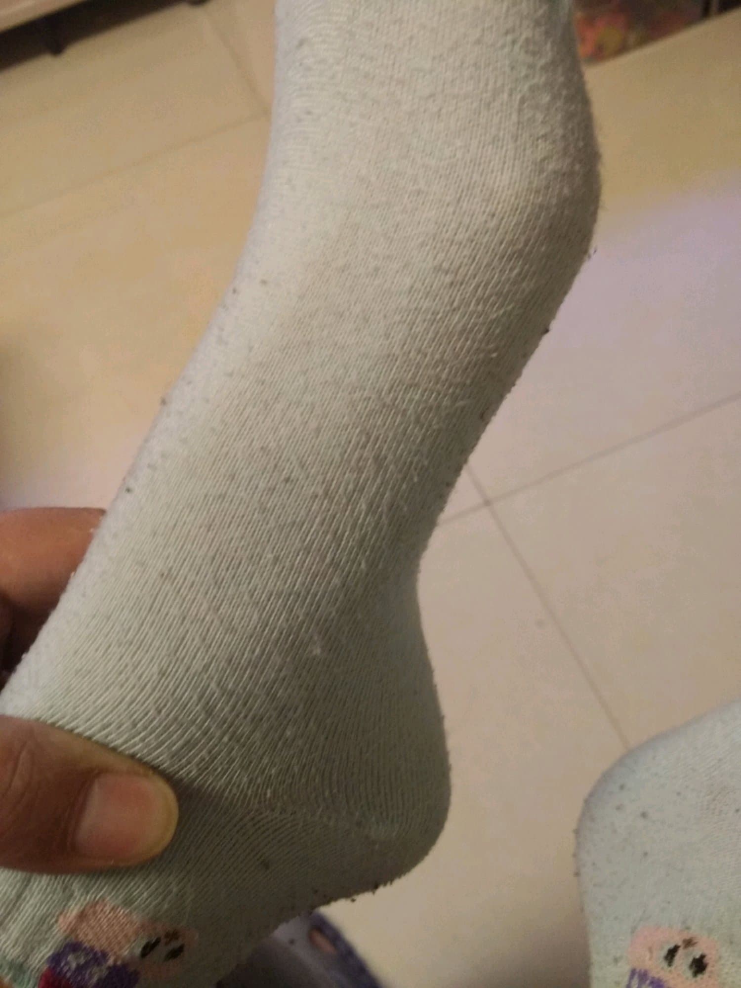 Sensual scene with hands massaging bare sole, fingers applying gentle pressure to arch under dim, warm lighting.