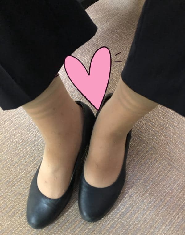 Assorted holiday nylons laid out on a suitcase, varied sheerness and lengths, hinting at travel and intimate wear during a trip.