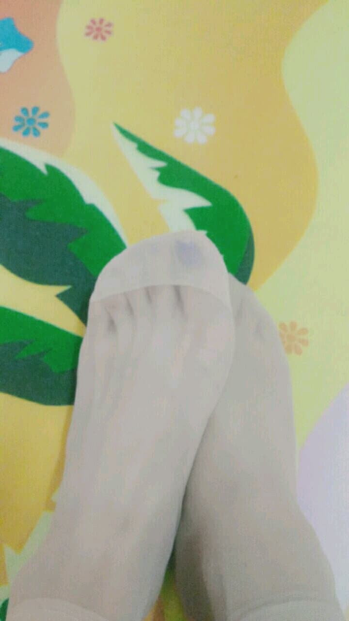 Bare foot next to stockinged leg