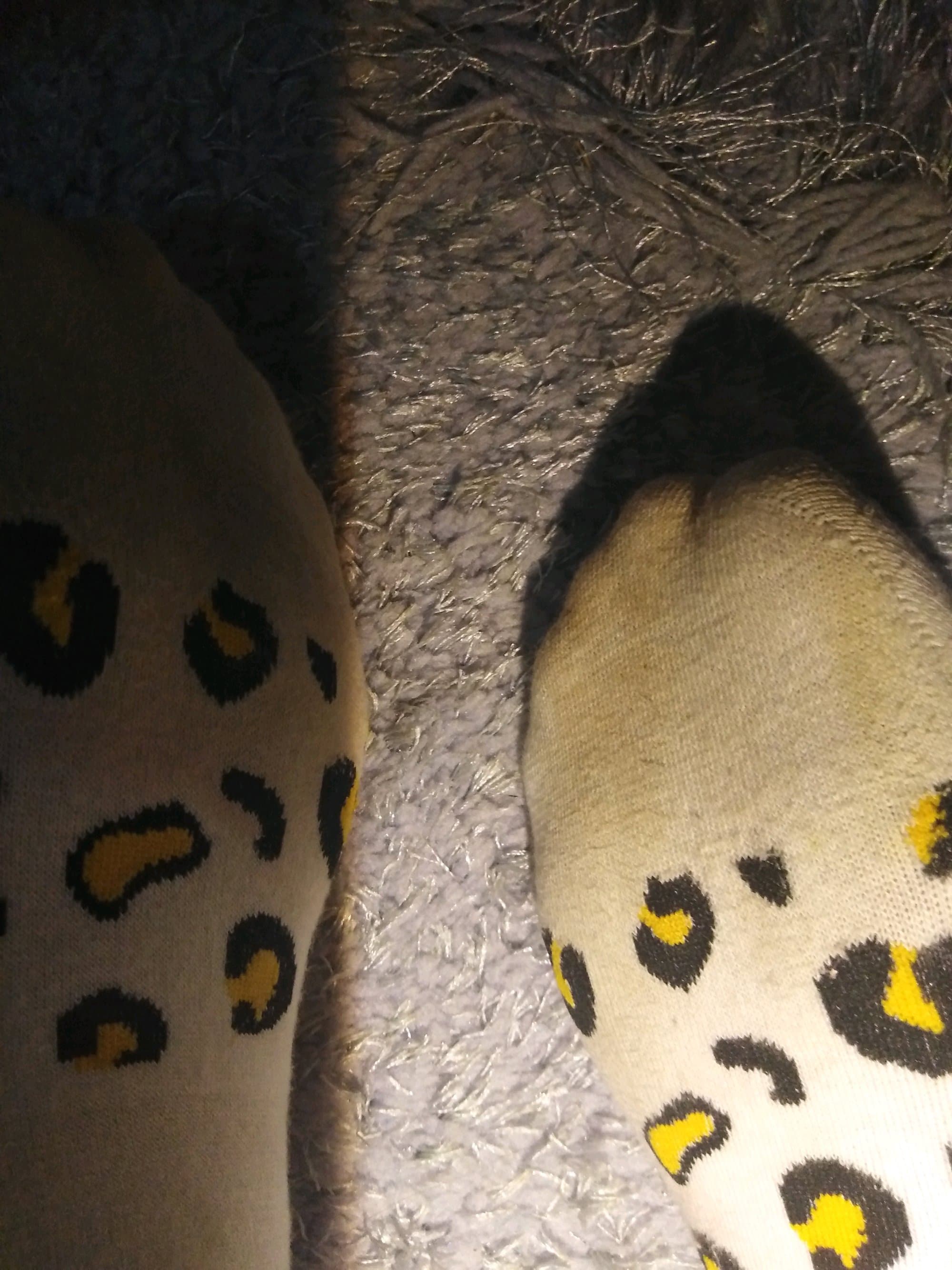 Rolled-down stockings with soft fabric stretches and exposed heel, hinting at several days of wear