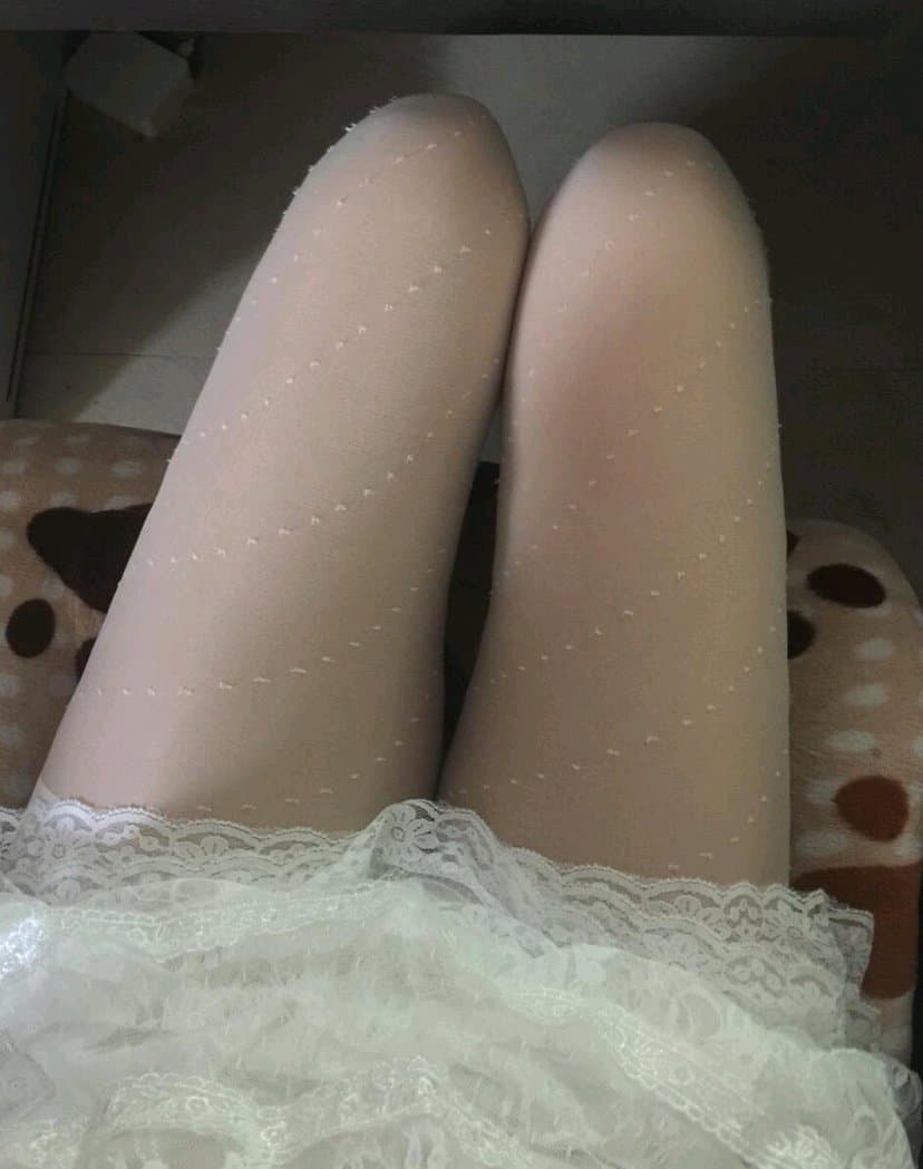 Close-up of bare Asian feet emerging from wrinkled white cotton socks with visible skin and soft arch detail