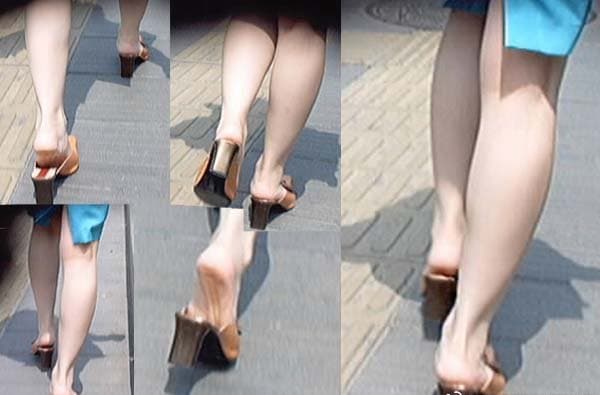 A pair of elegant bare feet stepping onto sunlit tiles, toes splayed, painted nails and soft arches visible.