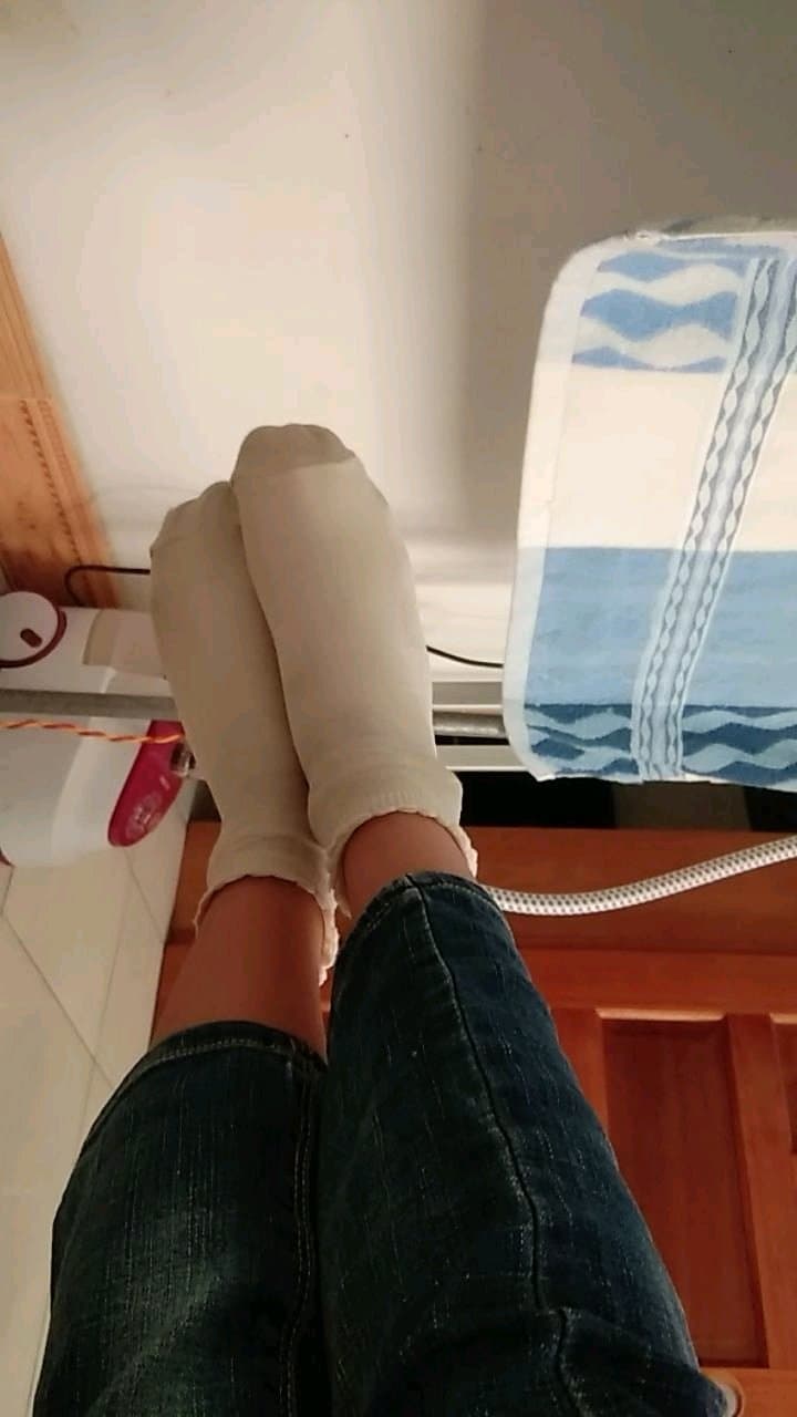 pile of assorted cotton socks with a bare ankle visible