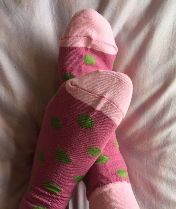 red polka dot cotton socks on pointed feet