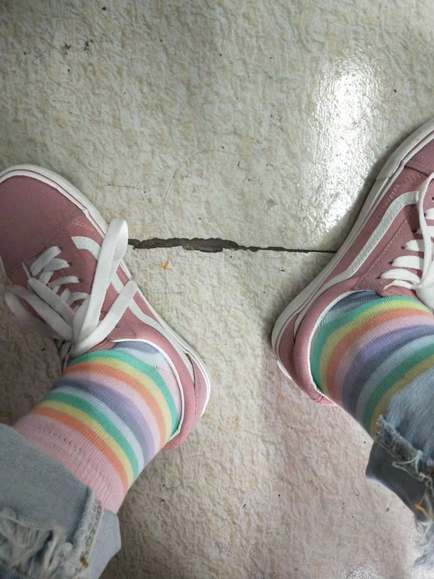 Rainbow hosiery on slender feet