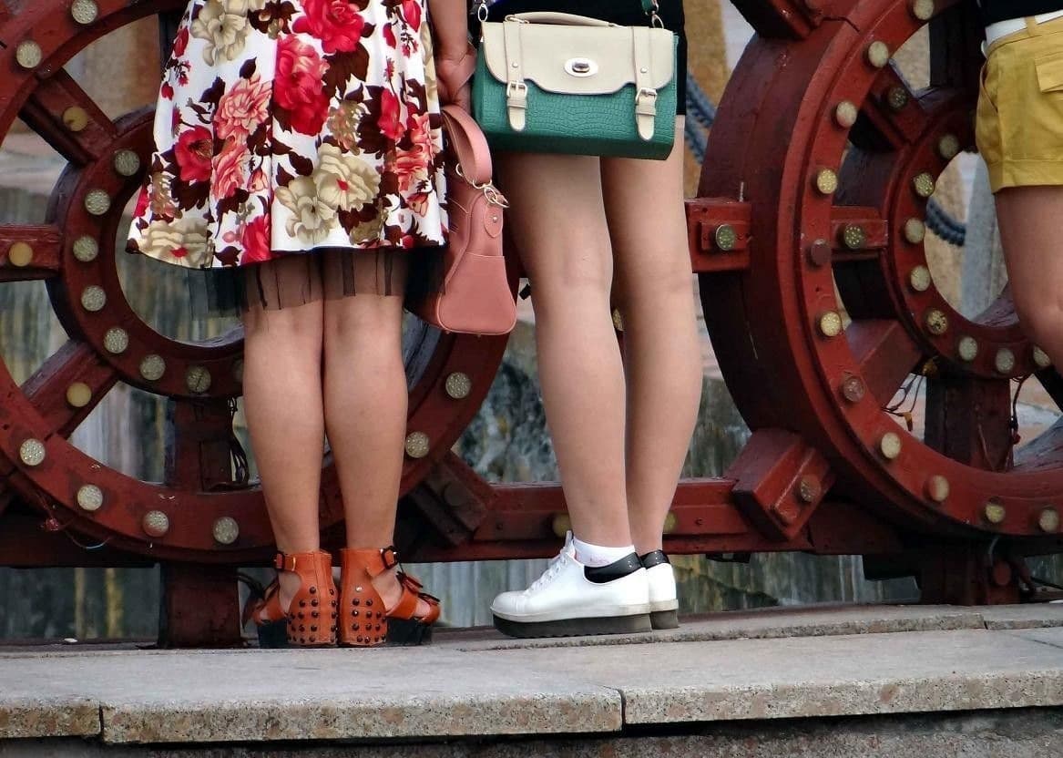 Barefoot encased in cotton sock with a sheer stocking layered over, fabric texture and ankle shown